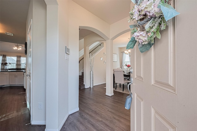 10434 Lake Of The Ozarks Dr, Humble, TX 77396 - foyer featuring arched walkways, dark wood-style floors, stairway, and a ceiling fan