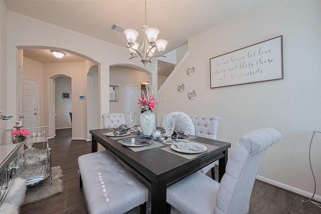 10434 Lake Of The Ozarks Dr, Humble, TX 77396 - dining area featuring arched walkways, a chandelier, and dark wood-type flooring