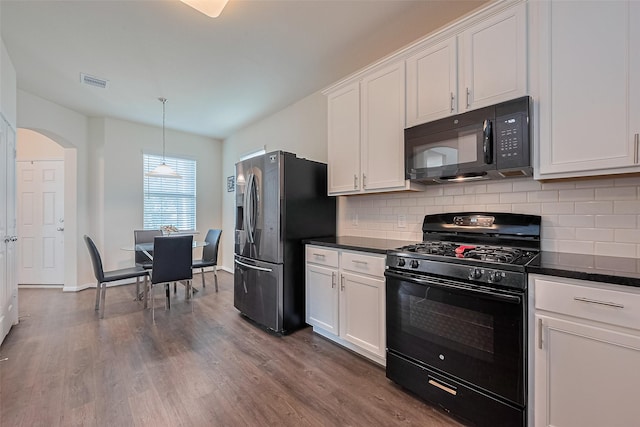 10434 Lake Of The Ozarks Dr, Humble, TX 77396 - kitchen with black appliances, decorative backsplash, and white cabinets