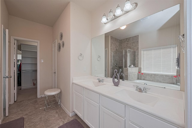 10434 Lake Of The Ozarks Dr, Humble, TX 77396 - bathroom featuring a shower stall, double vanity, a walk in closet, a garden tub, and tile patterned flooring