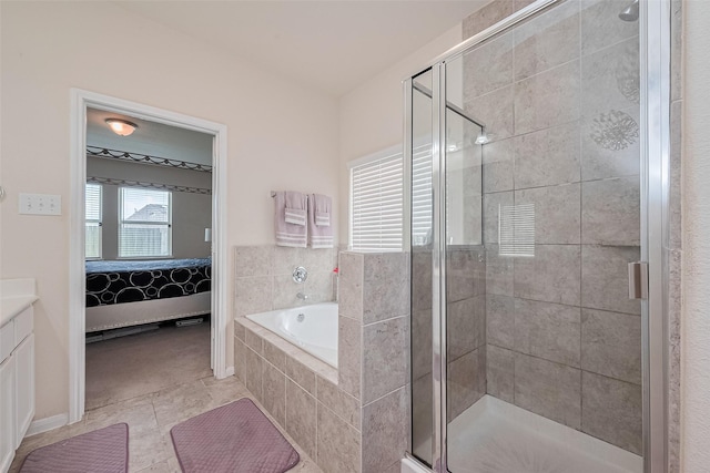 10434 Lake Of The Ozarks Dr, Humble, TX 77396 - ensuite bathroom with vanity, a garden tub, a shower stall, and tile patterned flooring