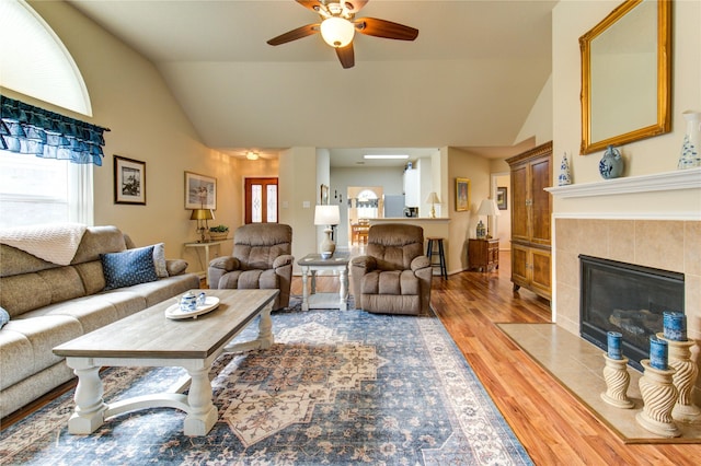 19238 Ashford Square St, Tomball, TX 77375 - living area with ceiling fan, light wood finished floors, plenty of natural light, a tile fireplace, and high vaulted ceiling