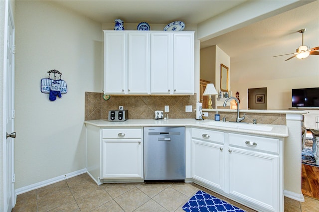 19238 Ashford Square St, Tomball, TX 77375 - kitchen with stainless steel dishwasher, a peninsula, backsplash, light countertops, and light tile patterned floors