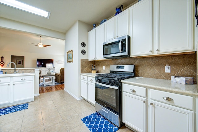 19238 Ashford Square St, Tomball, TX 77375 - kitchen with stainless steel appliances, open floor plan, tasteful backsplash, light countertops, and white cabinets