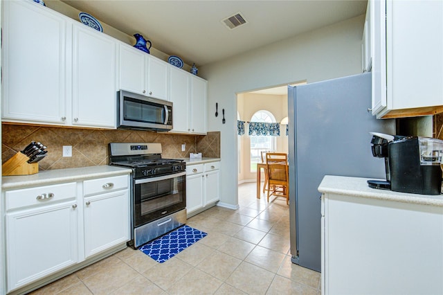 19238 Ashford Square St, Tomball, TX 77375 - kitchen featuring stainless steel appliances, backsplash, light countertops, and white cabinetry