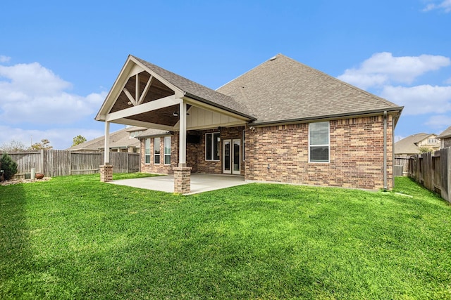 13603 Sandford Meadow Ln, Cypress, TX 77429 - back of house featuring a shingled roof, a patio, brick siding, and a fenced backyard