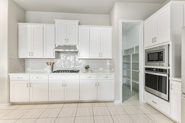 13603 Sandford Meadow Ln, Cypress, TX 77429 - kitchen with stainless steel appliances, under cabinet range hood, light countertops, white cabinetry, and tasteful backsplash