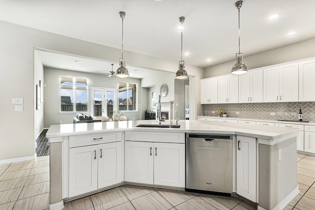 13603 Sandford Meadow Ln, Cypress, TX 77429 - kitchen with stainless steel dishwasher, tasteful backsplash, light countertops, white cabinets, and recessed lighting