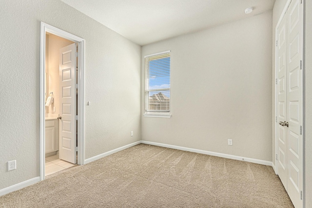 13603 Sandford Meadow Ln, Cypress, TX 77429 - unfurnished bedroom with light carpet, a closet, and ensuite bathroom