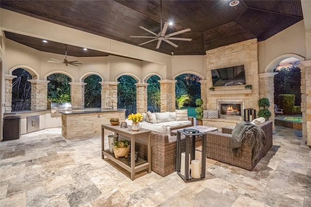 27 S Glenwild Cir, The Woodlands, TX 77389 - view of patio featuring a ceiling fan, area for grilling, and an outdoor living space with a fireplace