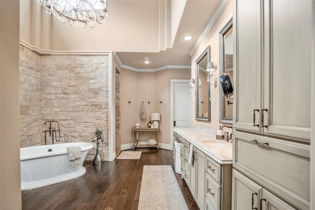 27 S Glenwild Cir, The Woodlands, TX 77389 - bathroom featuring vanity, crown molding, a soaking tub, recessed lighting, and wood finished floors