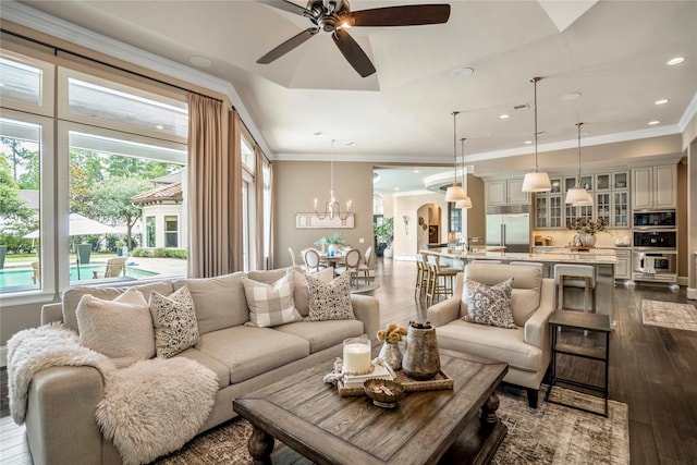 27 S Glenwild Cir, The Woodlands, TX 77389 - living room with dark wood-style floors, a ceiling fan, arched walkways, a chandelier, and crown molding