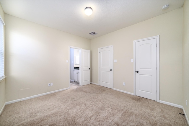 19503 S Coral Honeysuckle Loop, Cypress, TX 77433 - unfurnished bedroom with light carpet and ensuite bathroom