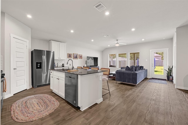 225 Big Spring Dr, Anahuac, TX 77514 - kitchen with stainless steel appliances, an island with sink, white cabinetry, ceiling fan, and dark wood-style floors