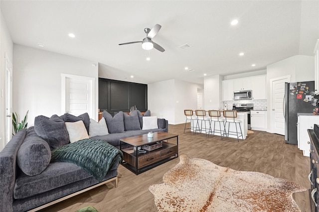 225 Big Spring Dr, Anahuac, TX 77514 - living room with light wood finished floors, ceiling fan, and recessed lighting