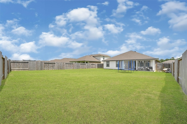 225 Big Spring Dr, Anahuac, TX 77514 - fenced backyard with a trampoline