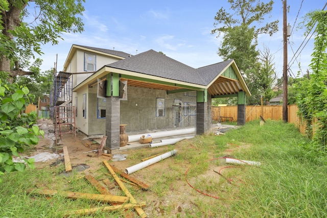959 Althea Dr, Houston, TX 77018 - rear view of house featuring a shingled roof and stairs
