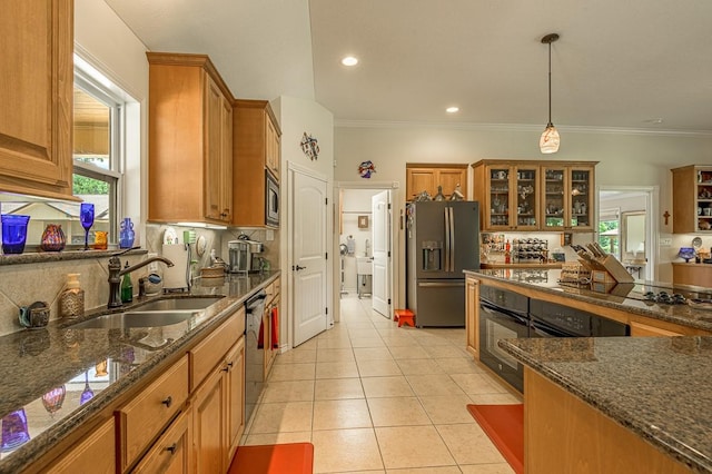 33 Lakeside, Trinity, TX 75862 - kitchen featuring black appliances, brown cabinets, tasteful backsplash, healthy amount of natural light, and ornamental molding