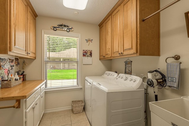 33 Lakeside, Trinity, TX 75862 - washroom featuring cabinet space, washing machine and clothes dryer, and light tile patterned floors
