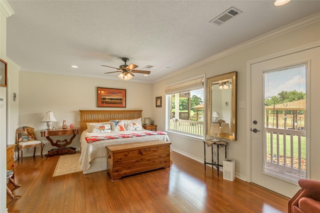 33 Lakeside, Trinity, TX 75862 - bedroom featuring wood finished floors, crown molding, recessed lighting, a textured ceiling, and ceiling fan