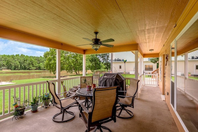 33 Lakeside, Trinity, TX 75862 - covered porch with a water view, a lawn, a ceiling fan, and outdoor dining space