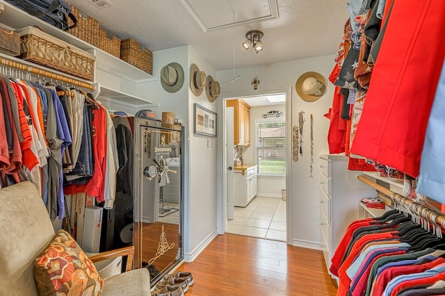 33 Lakeside, Trinity, TX 75862 - walk in closet featuring attic access and wood finished floors