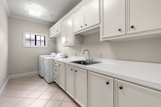 1013 Mulberry Ln, Bellaire, TX 77401 - laundry area featuring separate washer and dryer, cabinet space, crown molding, and light tile patterned flooring