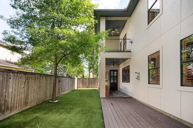 1013 Mulberry Ln, Bellaire, TX 77401 - fenced backyard with a ceiling fan, a balcony, and a wooden deck