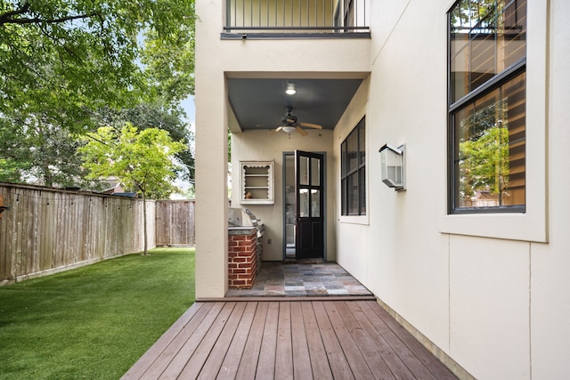 1013 Mulberry Ln, Bellaire, TX 77401 - doorway to property with ceiling fan, stucco siding, and a wooden deck