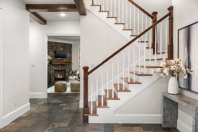 1013 Mulberry Ln, Bellaire, TX 77401 - staircase featuring a stone fireplace, stone finish floors, and beam ceiling