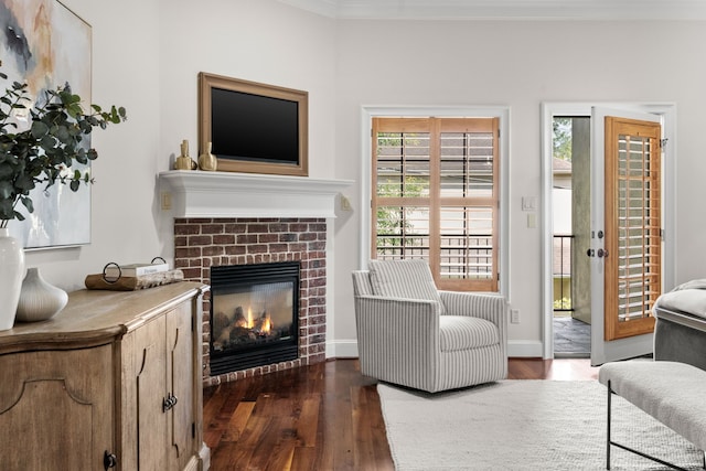 1013 Mulberry Ln, Bellaire, TX 77401 - living room featuring a brick fireplace, dark wood-style flooring, and ornamental molding