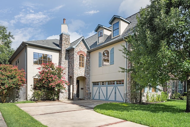 1013 Mulberry Ln, Bellaire, TX 77401 - view of front of home with stone siding, stucco siding, an attached garage, and concrete driveway