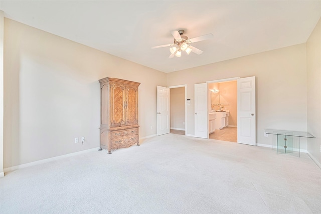 1814 Ferndale Lake Ct, Richmond, TX 77406 - unfurnished bedroom featuring light carpet, connected bathroom, and a ceiling fan