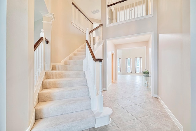 1814 Ferndale Lake Ct, Richmond, TX 77406 - staircase featuring a towering ceiling and tile patterned flooring