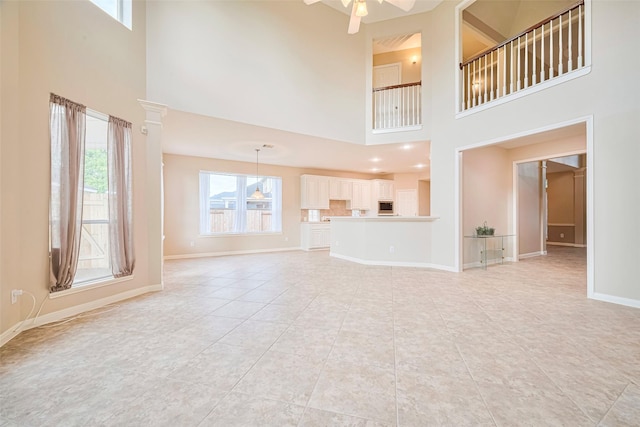 1814 Ferndale Lake Ct, Richmond, TX 77406 - unfurnished living room featuring a towering ceiling, a ceiling fan, and light tile patterned flooring