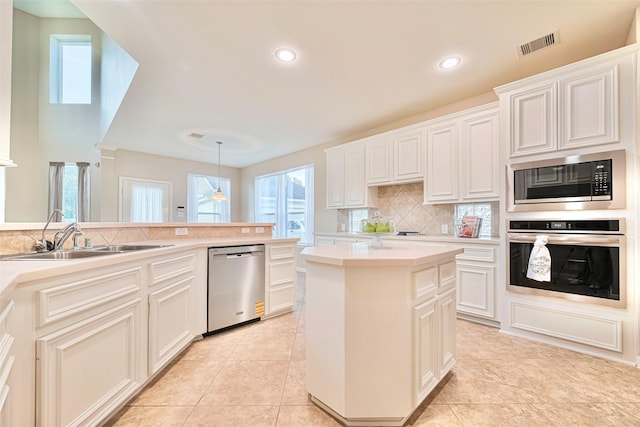 1814 Ferndale Lake Ct, Richmond, TX 77406 - kitchen with appliances with stainless steel finishes, tasteful backsplash, light countertops, recessed lighting, and white cabinetry
