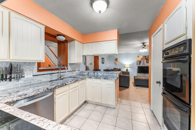 6103 Sunnygate Dr, Spring, TX 77373 - kitchen featuring dishwasher, a peninsula, a ceiling fan, a textured ceiling, and decorative backsplash