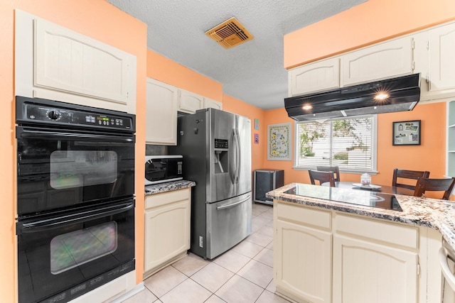 6103 Sunnygate Dr, Spring, TX 77373 - kitchen with black appliances, light tile patterned floors, under cabinet range hood, a textured ceiling, and light stone countertops