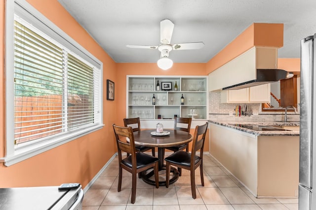 6103 Sunnygate Dr, Spring, TX 77373 - dining room with light tile patterned floors and a ceiling fan
