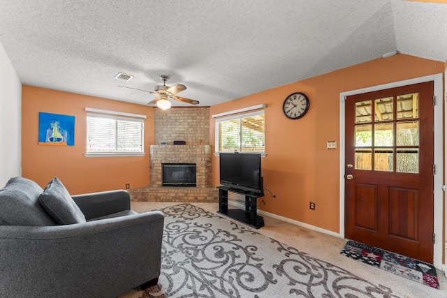 6103 Sunnygate Dr, Spring, TX 77373 - carpeted living room with a fireplace, ceiling fan, plenty of natural light, and a textured ceiling