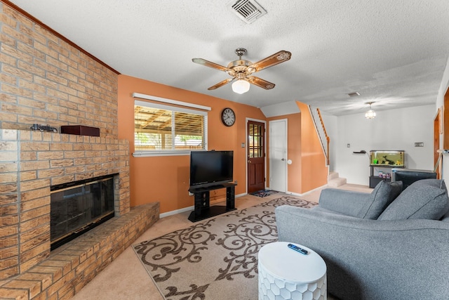 6103 Sunnygate Dr, Spring, TX 77373 - carpeted living room with a brick fireplace, stairway, a textured ceiling, and ceiling fan