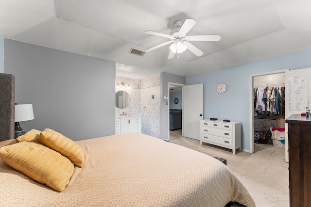 6103 Sunnygate Dr, Spring, TX 77373 - bedroom with a walk in closet, light colored carpet, ensuite bathroom, and ceiling fan