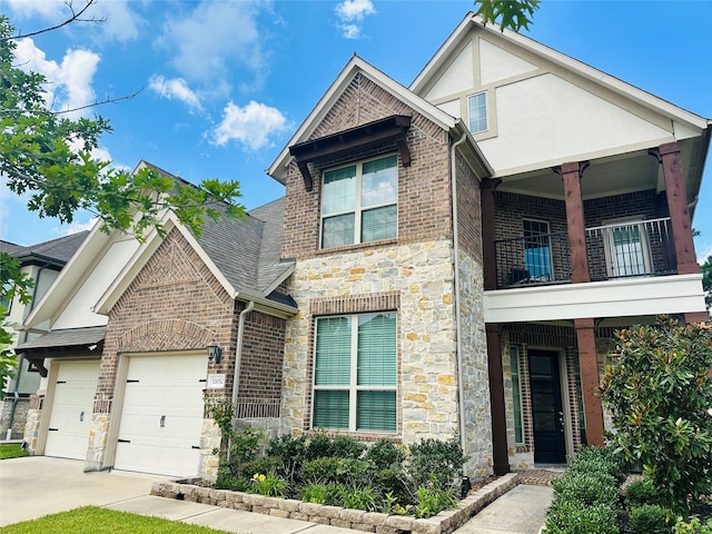 32052 Autumn Orchard Ln, Conroe, TX 77385 - view of front of house with a balcony, stone siding, an attached garage, concrete driveway, and brick siding