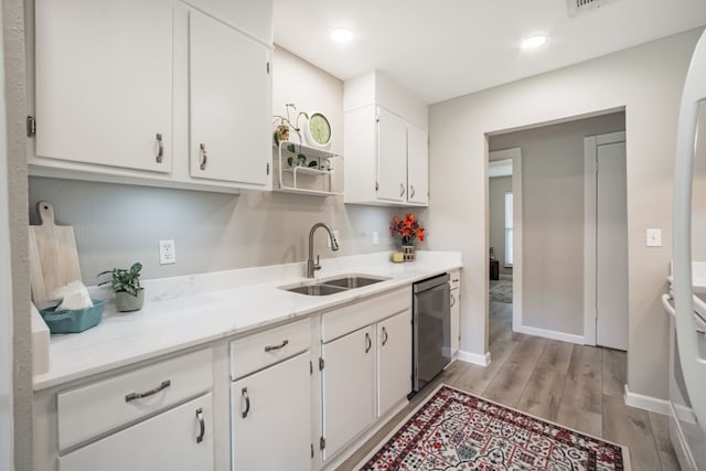 22002 Silver Lode Dr, Katy, TX 77450 - kitchen featuring stainless steel dishwasher, white cabinetry, light wood-style flooring, and light stone counters