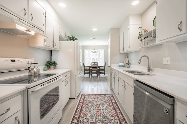 22002 Silver Lode Dr, Katy, TX 77450 - kitchen featuring white range with electric cooktop, dishwasher, under cabinet range hood, white cabinetry, and recessed lighting