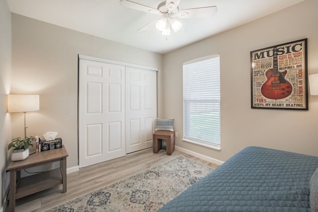 22002 Silver Lode Dr, Katy, TX 77450 - bedroom with multiple windows, light wood-style floors, a closet, and ceiling fan