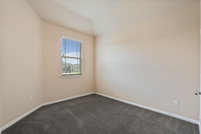 11053 Patriot Ct, Cleveland, TX 77328 - empty room with dark colored carpet and lofted ceiling