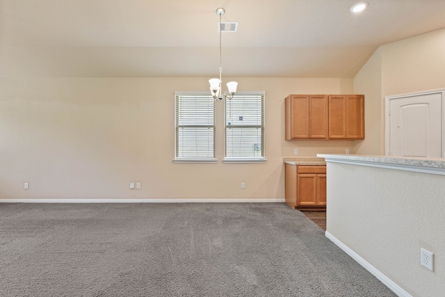 11053 Patriot Ct, Cleveland, TX 77328 - kitchen featuring a chandelier, dark colored carpet, light countertops, pendant lighting, and lofted ceiling