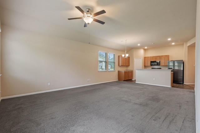 11053 Patriot Ct, Cleveland, TX 77328 - unfurnished living room with ceiling fan, dark colored carpet, recessed lighting, and a chandelier