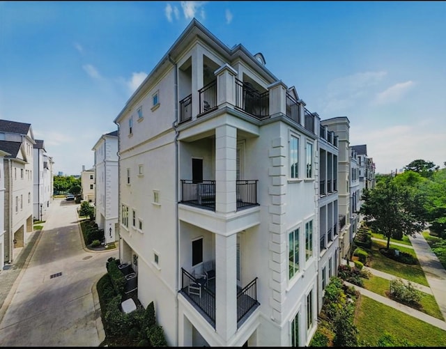 854 Dunleigh Meadows Ln, Houston, TX 77055 - view of side of property with a balcony and stucco siding